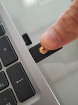 A finger pressing a usb drive into a computer AI-generated content may be incorrect.